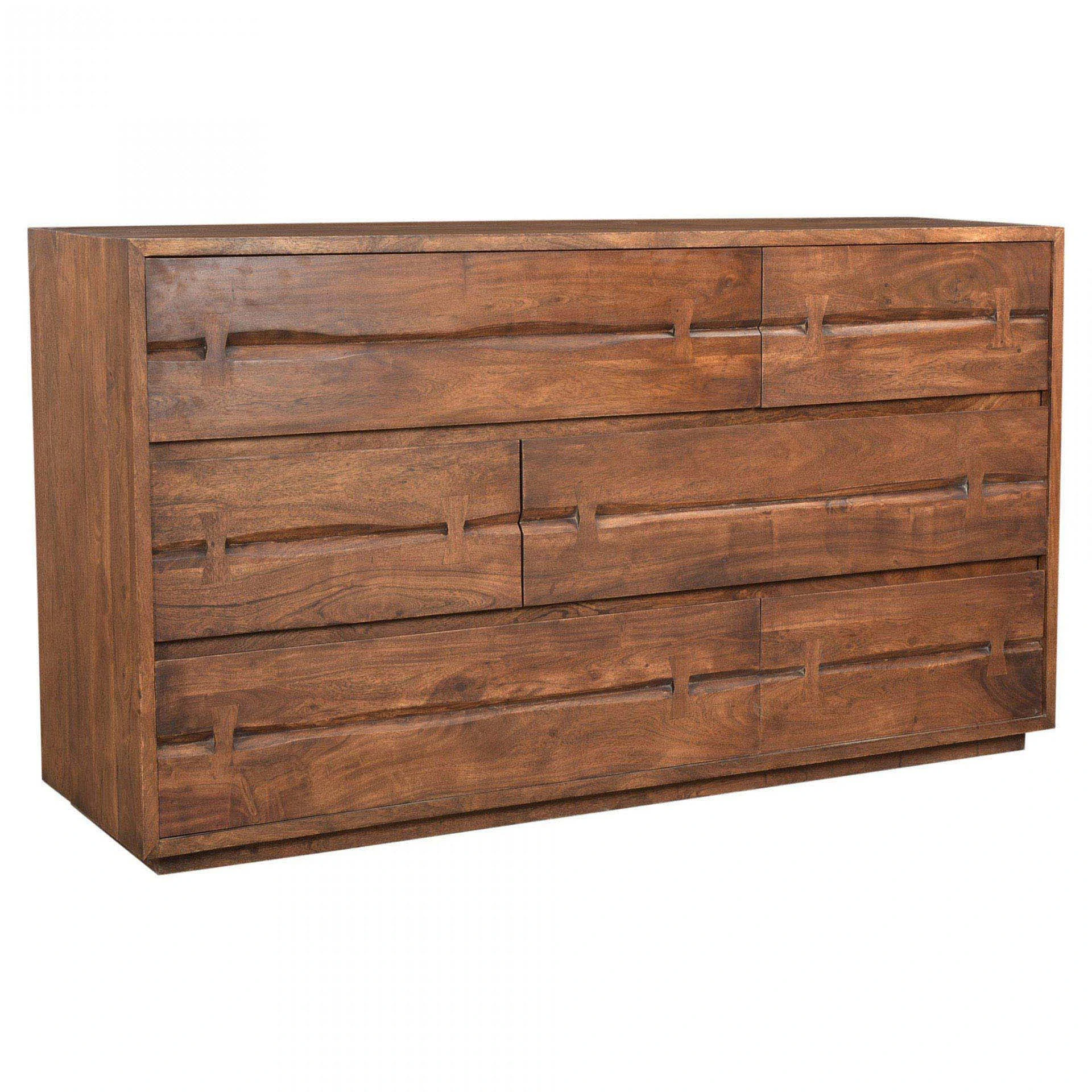 Close-up of drawer fronts showing horizontal carved slat handles integrated into the wood grain.