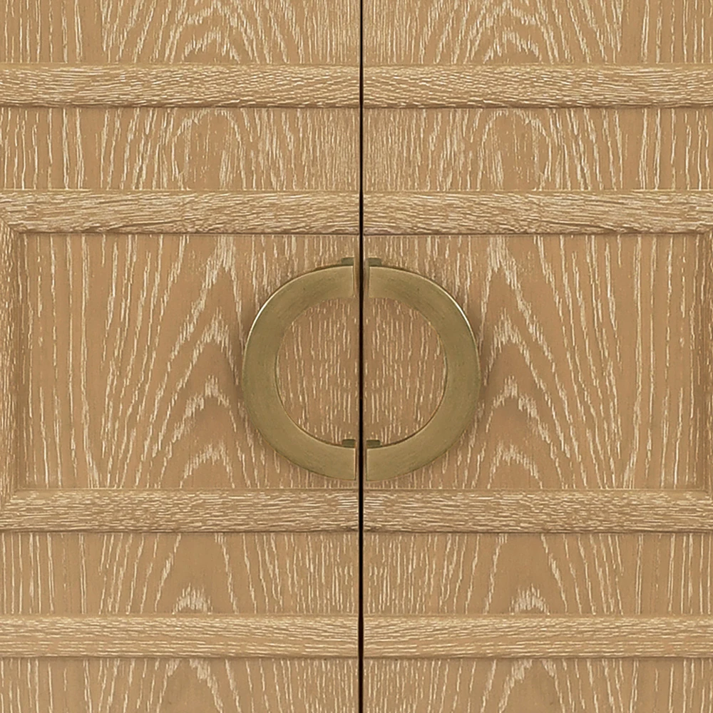 A close-up of the two doors of a light brown wooden vanity cabinet with gold handles.