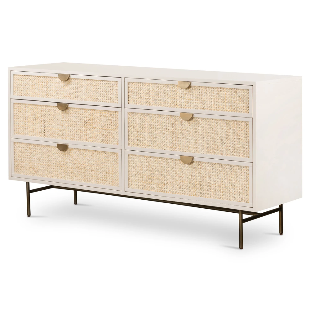 Close-up of woven cane drawer fronts and brushed brass handles on a cream-colored cabinet.