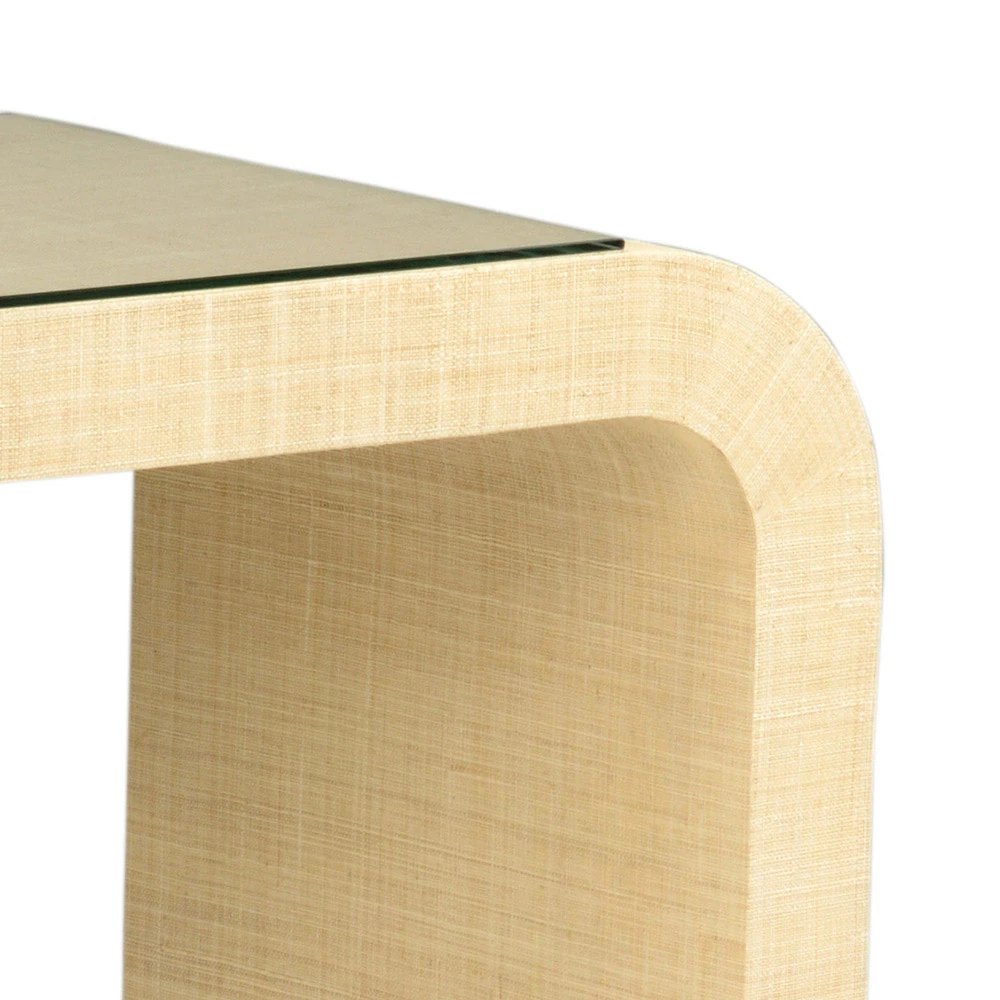 A close-up of the corner of a beige console table with a rounded edge.
