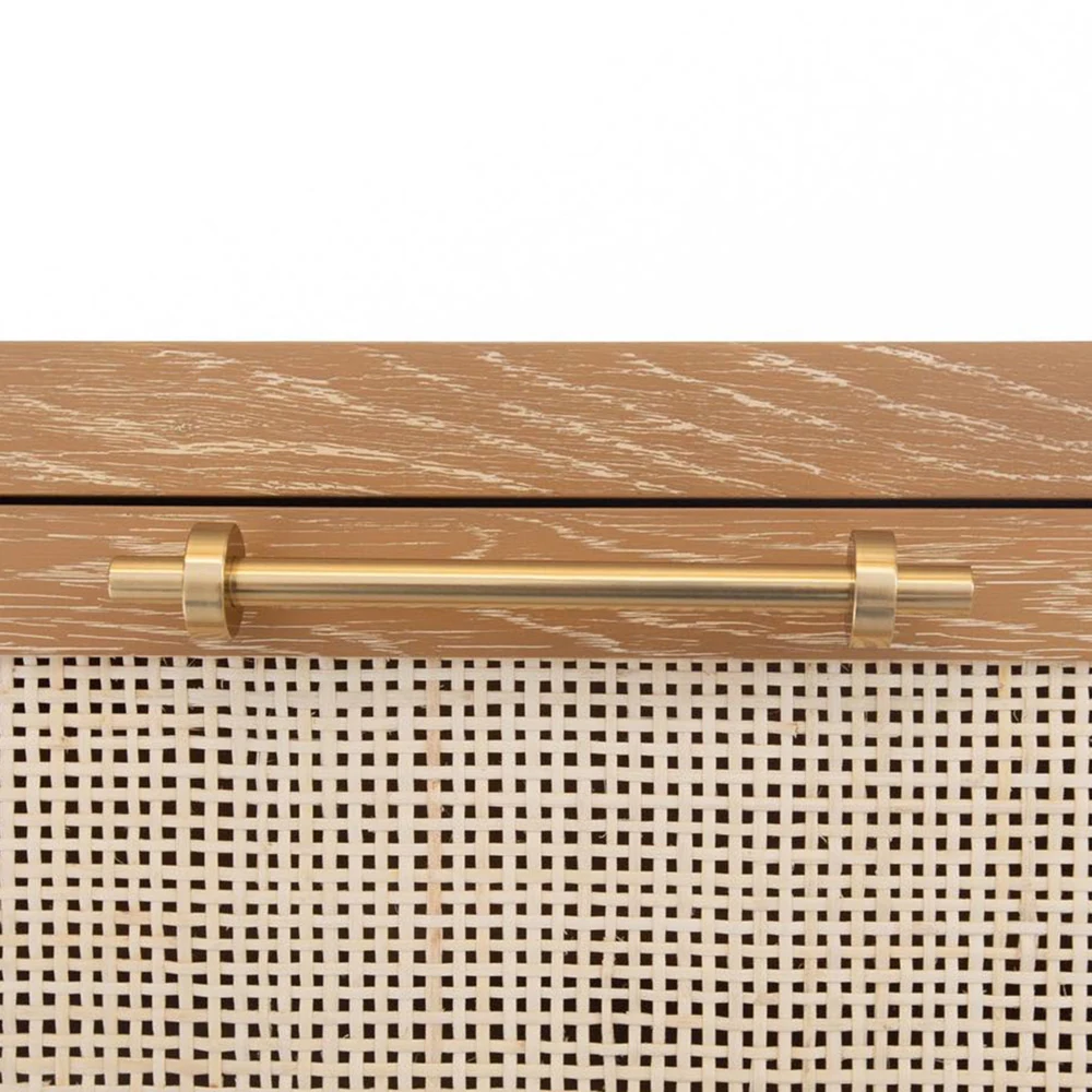 A close-up of a drawer handle and wicker front.
