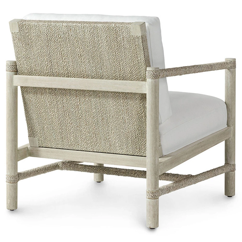 The back of a chair with a light wood frame and rope accents.