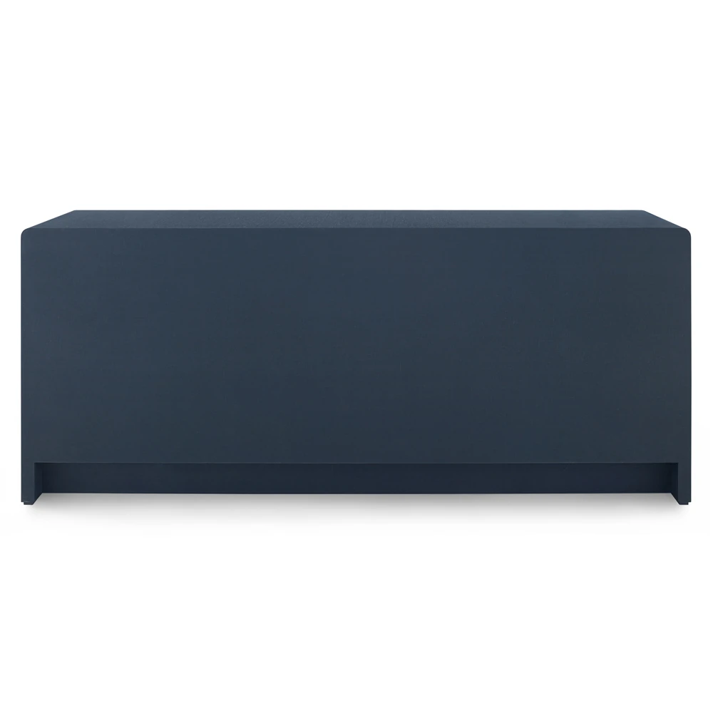 close-up of brass circular ring pull hardware on blue fabric-textured surface, front view