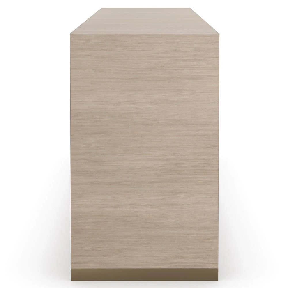 Close-up of two-tone wood dresser with three wide drawers featuring slim metallic pulls and a textured, stone-like drawer fronts.