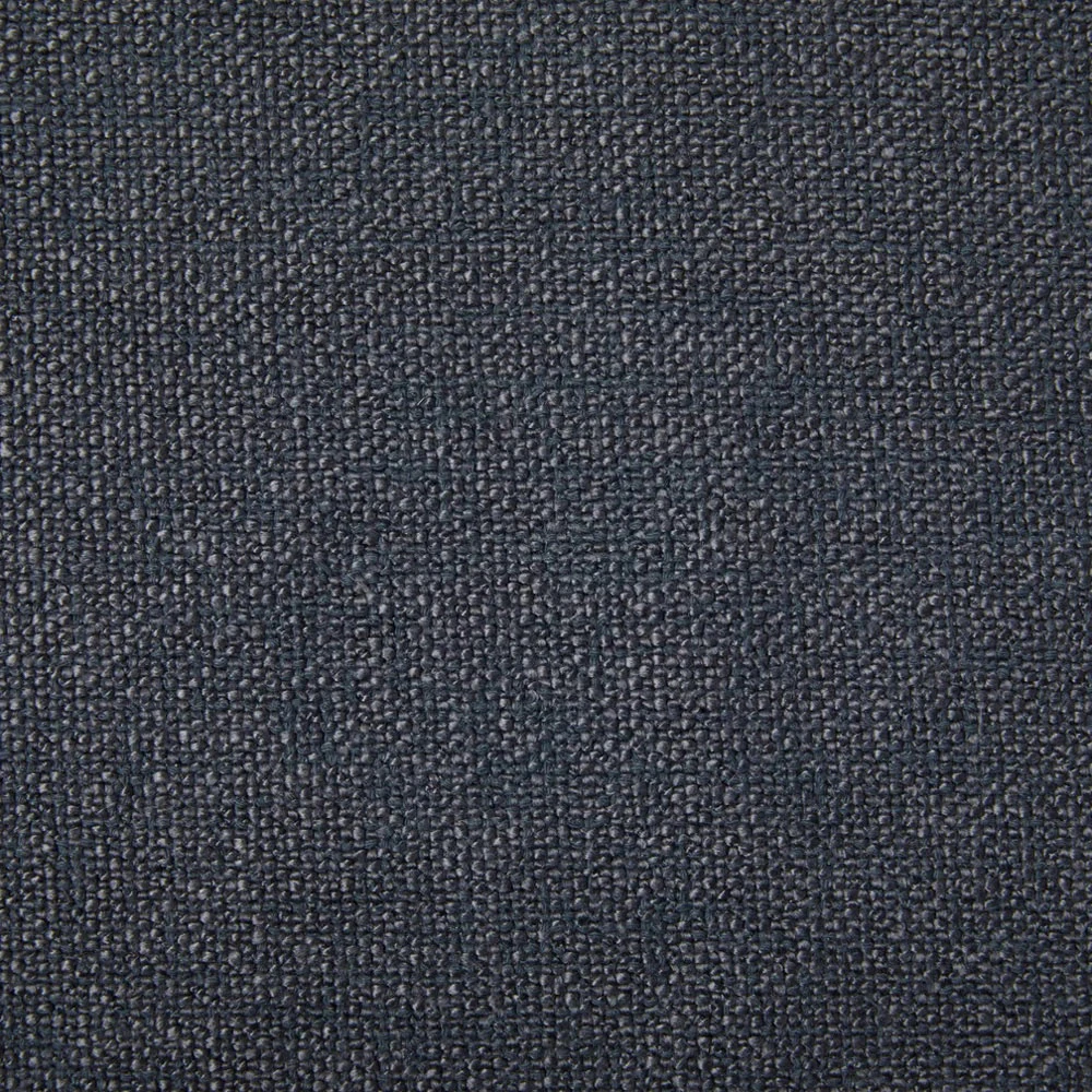 A close-up of the blue fabric of the armchair.