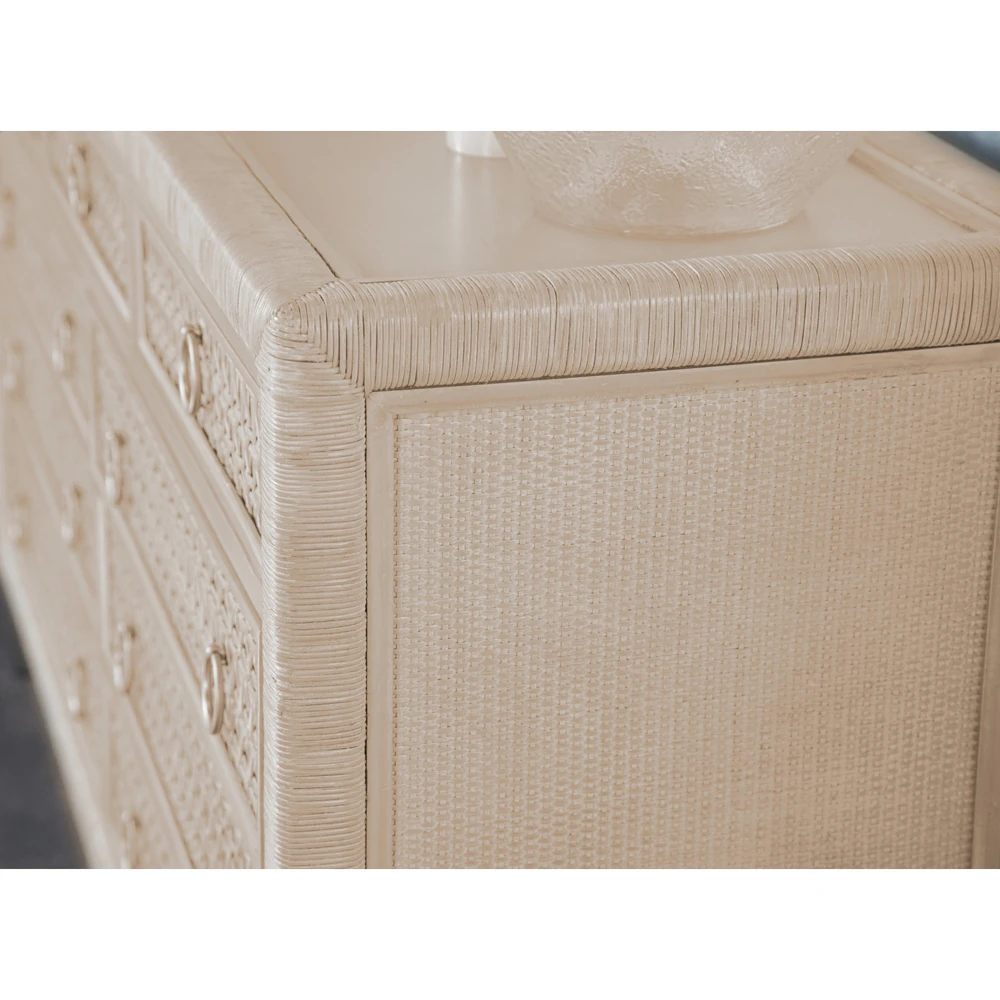 A close-up of a beige dresser's corner and woven pattern.
