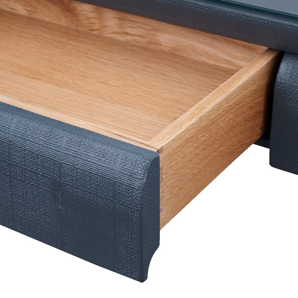 The open drawer of a navy blue table with a wooden interior.