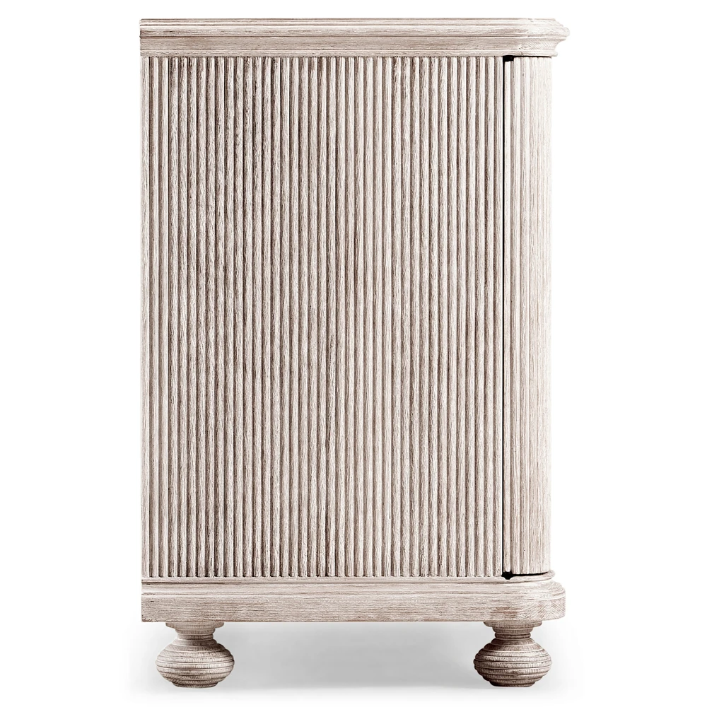 Close-up of cabinet corner showing curved top edge and grooves on wood surface.