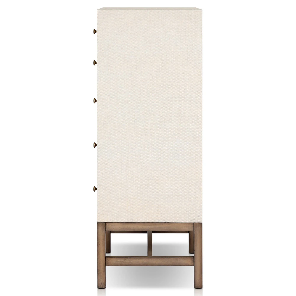 Detail of one drawer front with brass knob on textured beige fabric surface
