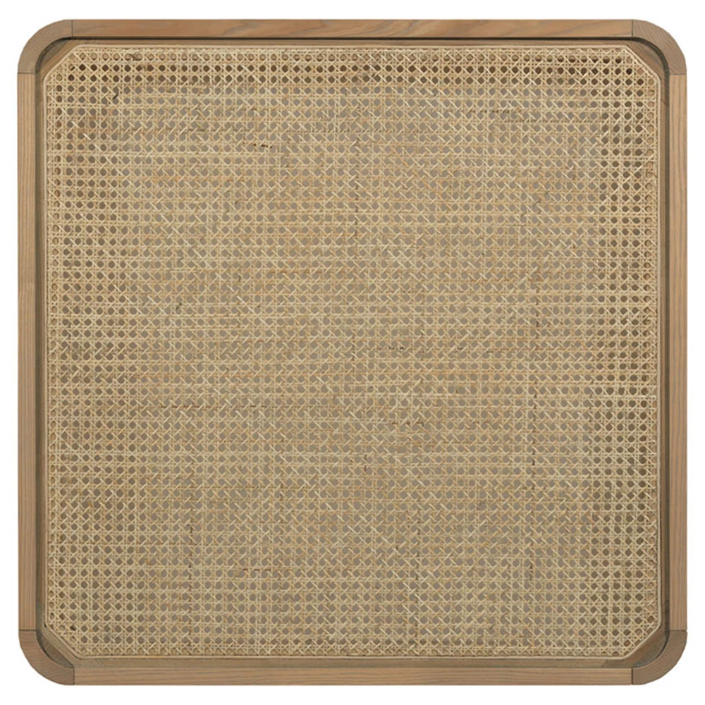 A close-up of a woven rattan table top with a light brown wooden frame