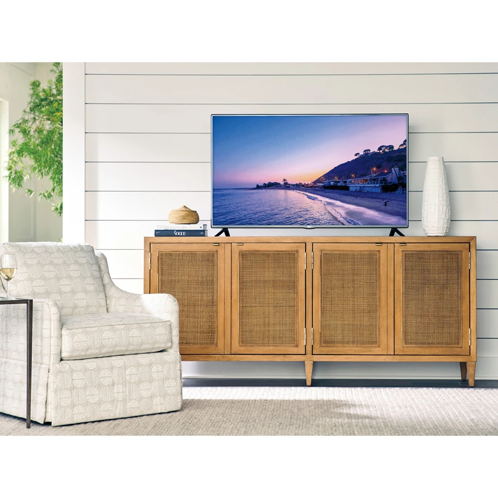 A wooden sideboard with closed cabinets, with a TV on top.
