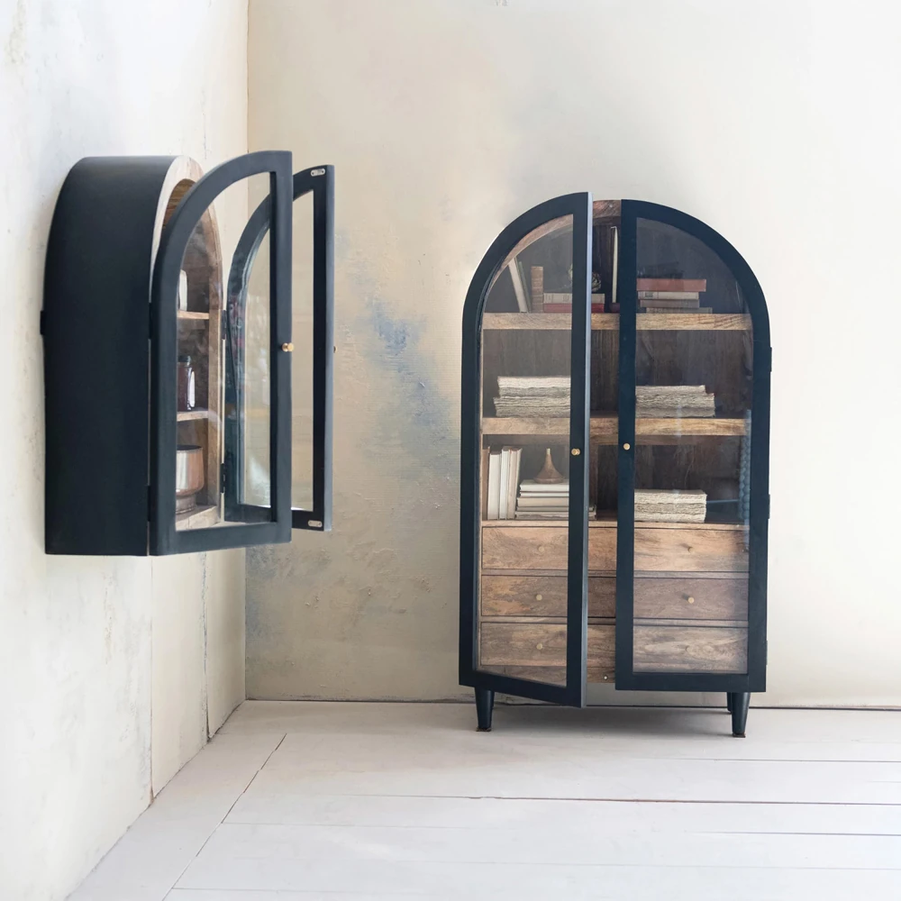 A black cabinet with glass doors and wooden shelves, with the doors open, showing the wall-mounted version