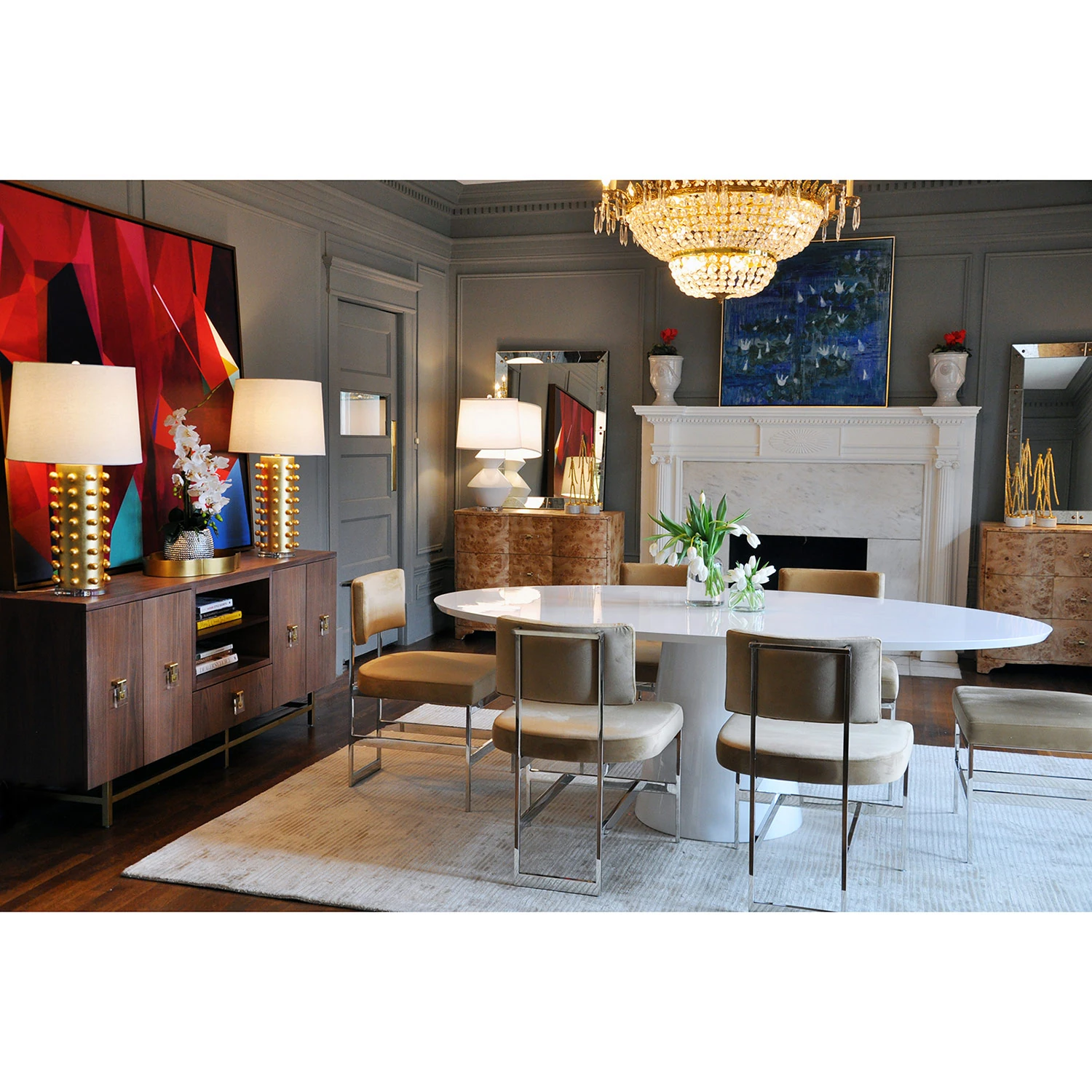 Luxurious dining room with crystal chandelier, dark gray walls, and large windows with shutters, featuring the round white table.