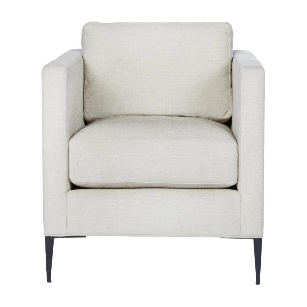 Close-up of the same cream fabric armchair showing front and side upholstery textures and slim legs.