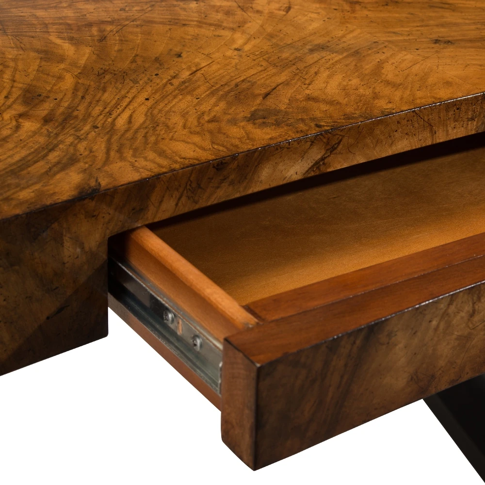 A close-up of the wooden table's drawer.