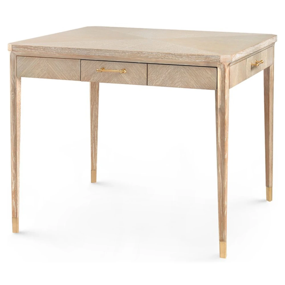 Close-up of drawer front showing light wood grain and brass handle on the desk.