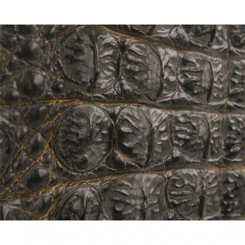 Wooden top edge and crocodile-textured panels on a dark sideboard, showing horizontal grain detail.