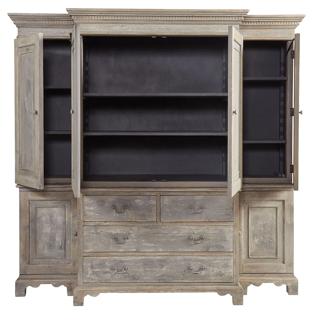 Close-up of lower drawer fronts and left foot of the distressed armoire, highlighting metal handles and scalloped base details.