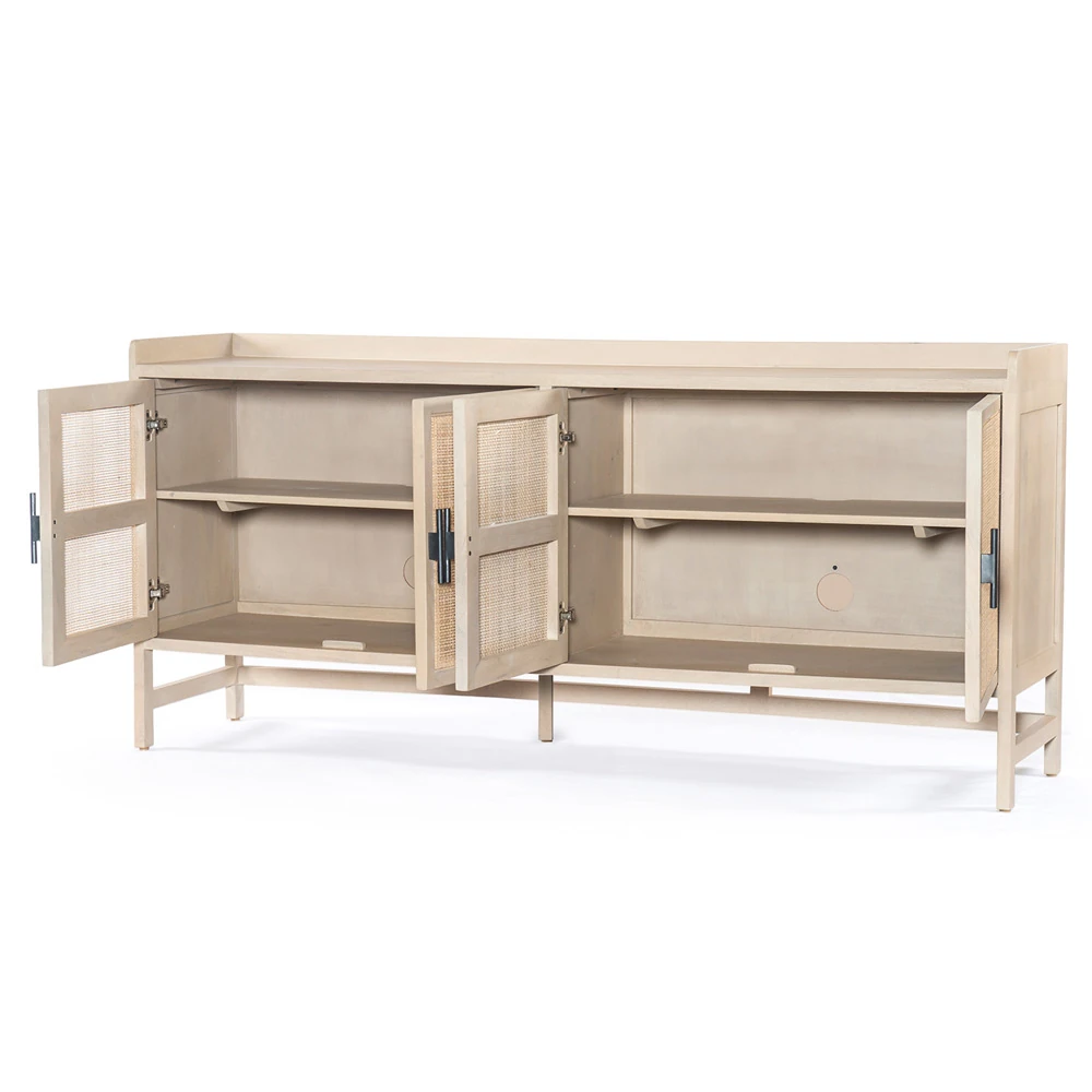 Wall art and decor arranged above a matching cane-panel sideboard, enhancing the coastal/modern look.