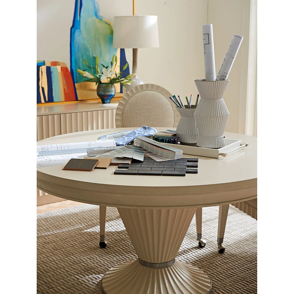 A white round table with various items on it.
